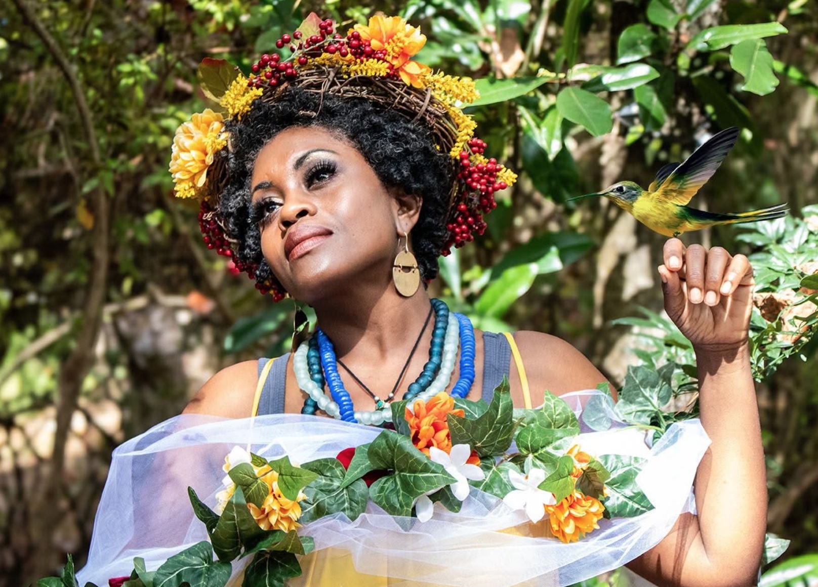 Jayme Alilaw wearing a flower crown, with a hummingbird